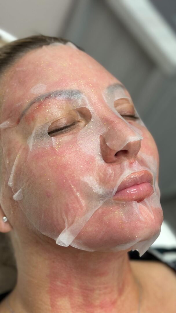 A woman with white facial mask on her face.