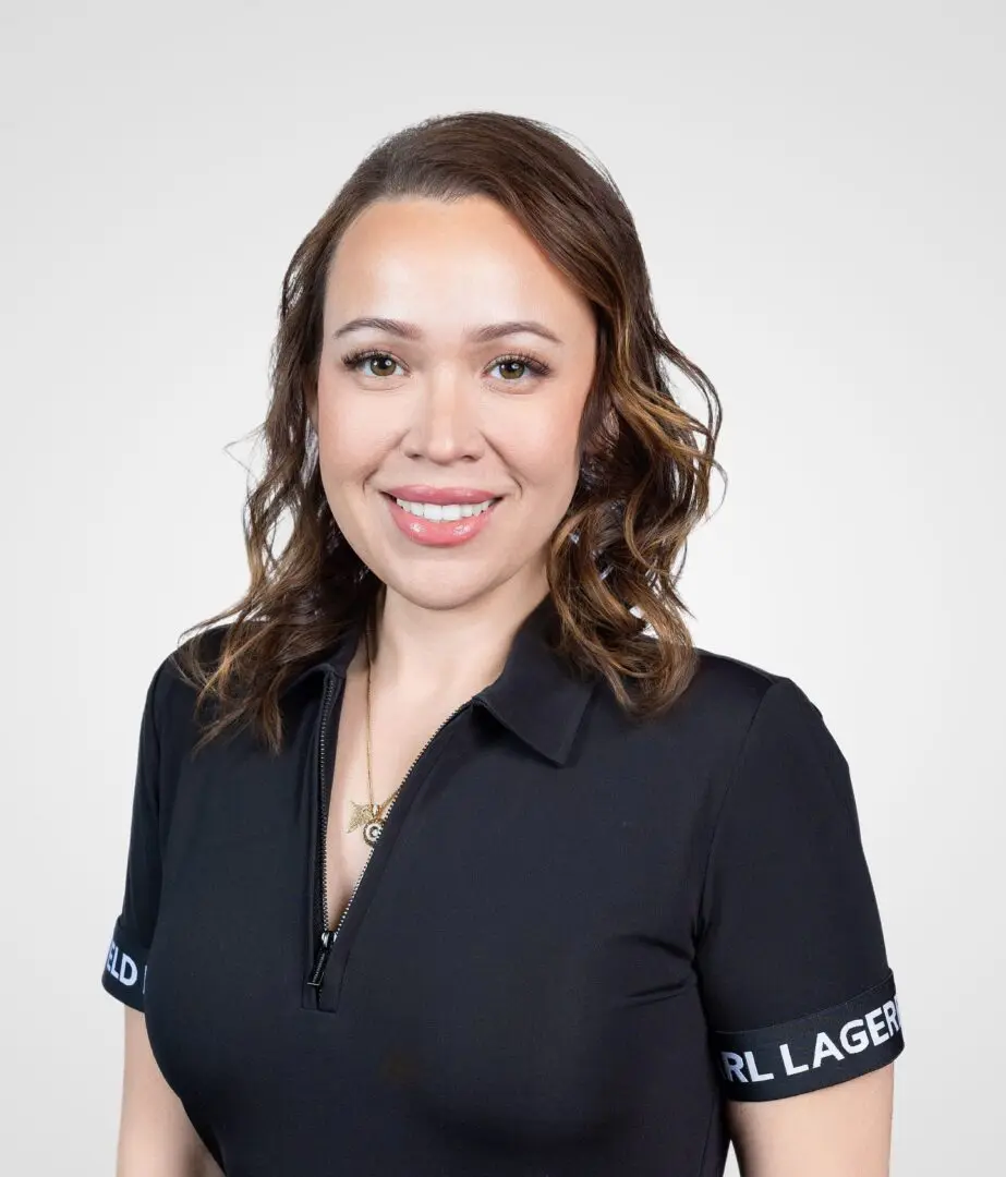 A woman in black shirt smiling for the camera.