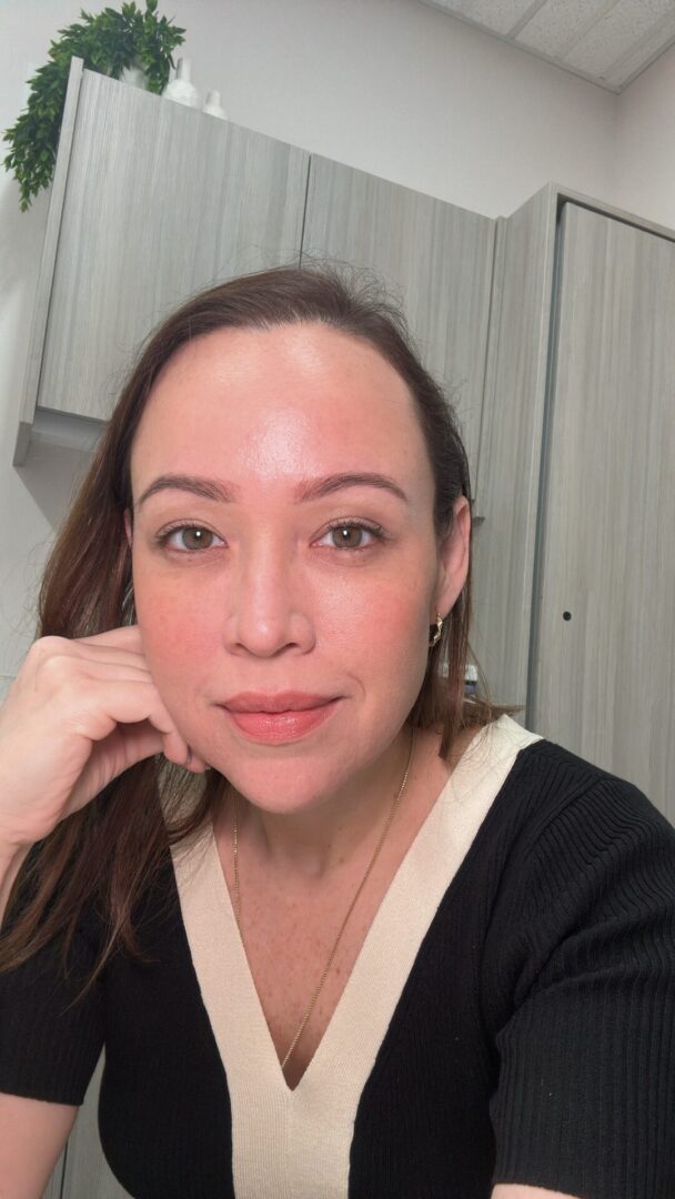 A woman with brown hair and wearing a black shirt.